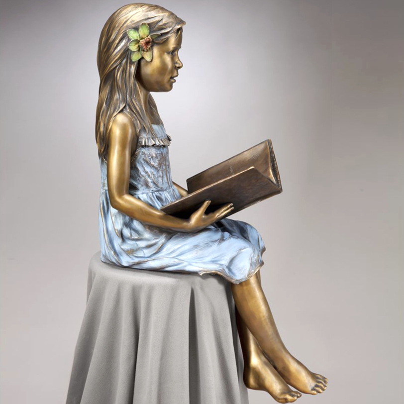 Lovely sitting bronze girl statue with reading